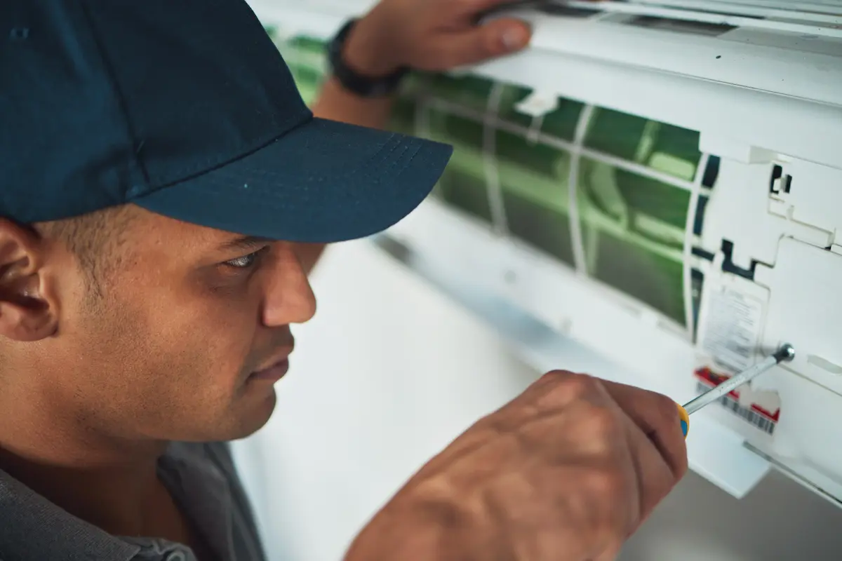 professional hvac technician performing yearly maintenance on evaporator head
